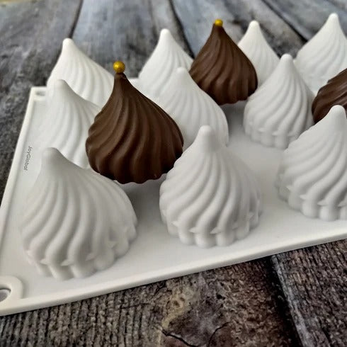 Deep red modak-shaped confections showing the crisp swirled detail from the silicone mould