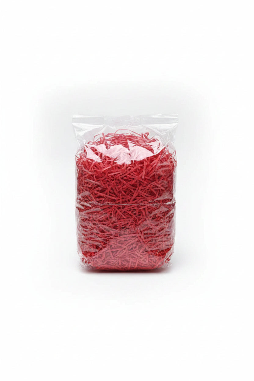 Red shredded wooden gift box filler in a clear bag