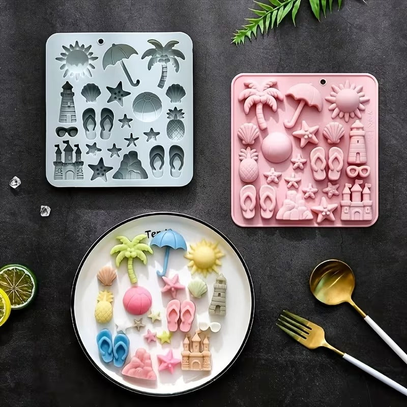 Pink and grey beach silicone moulds with finished beach figurines on a plate with cutlery
