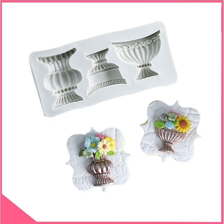 White silicone mould with brown, lavender and blue cast urn outputs and flower cake decoration
