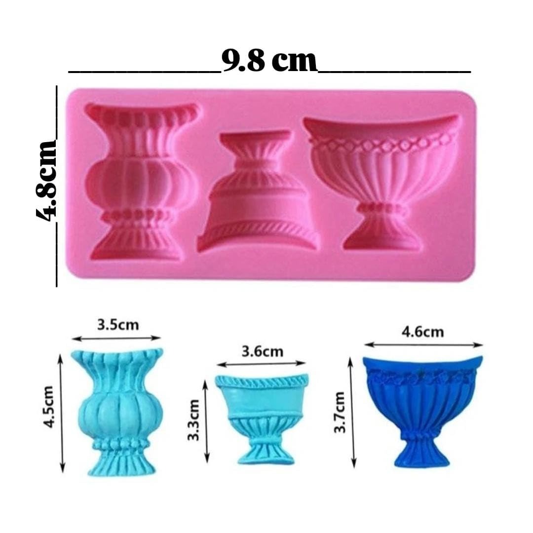 Pink silicone urn vase mould with coloured wax cast outputs in blue and teal