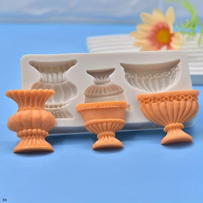 Pink silicone vase mould with purple, peach and blue cast urns and flower arrangement candle showcase
