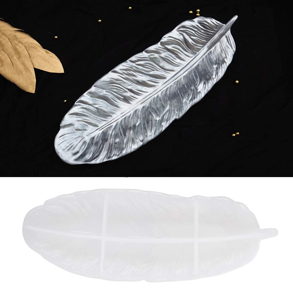 Feather silicone mold alongside gold feather casting and real feathers