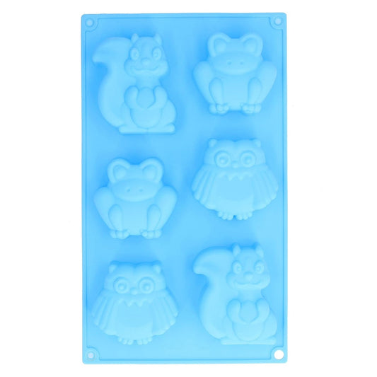 Blue 6-cavity woodland animals silicone mould with finished chocolate squirrel, owl and hedgehog figurines on a plate