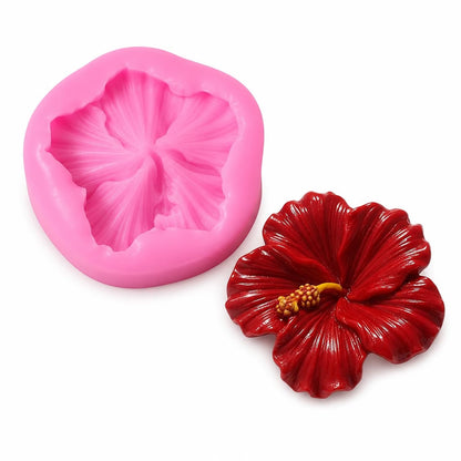 Red hibiscus flower candles in clear glass containers