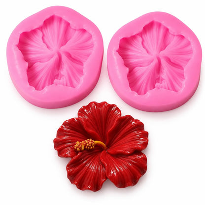 Flexible hibiscus silicone candle mold being demolded by hand