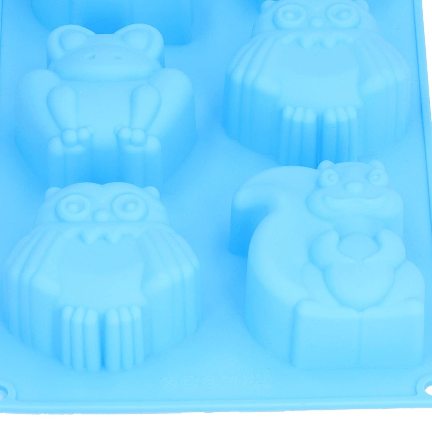 Blue woodland animals silicone mould with finished white chocolate squirrel, owl, hedgehog and frog figurines