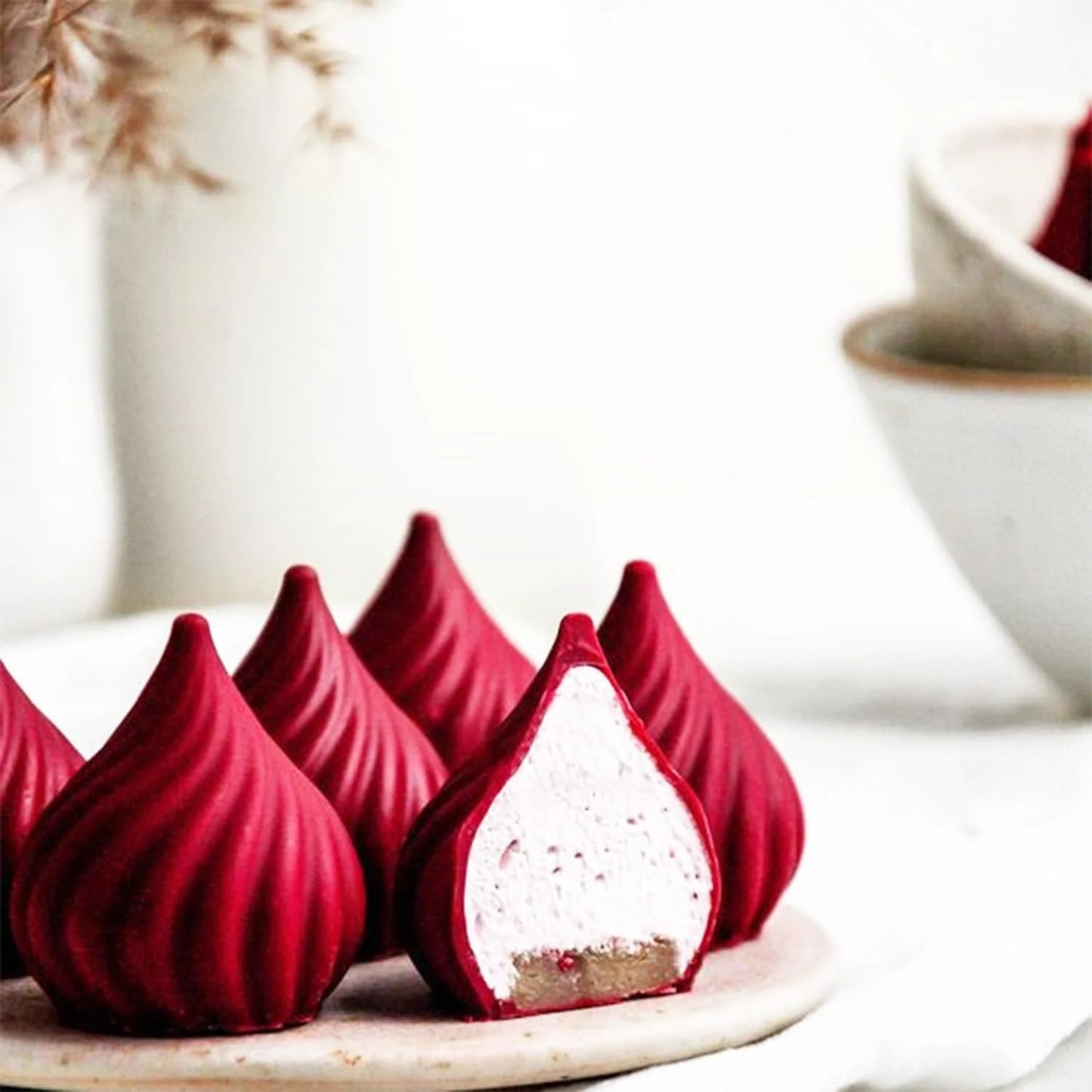 Modak silicone mould with finished candles – swirled ridged modak shape