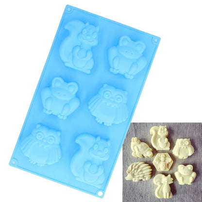 Blue woodland animals silicone mould with finished white chocolate figurines including squirrel, owl and hedgehog