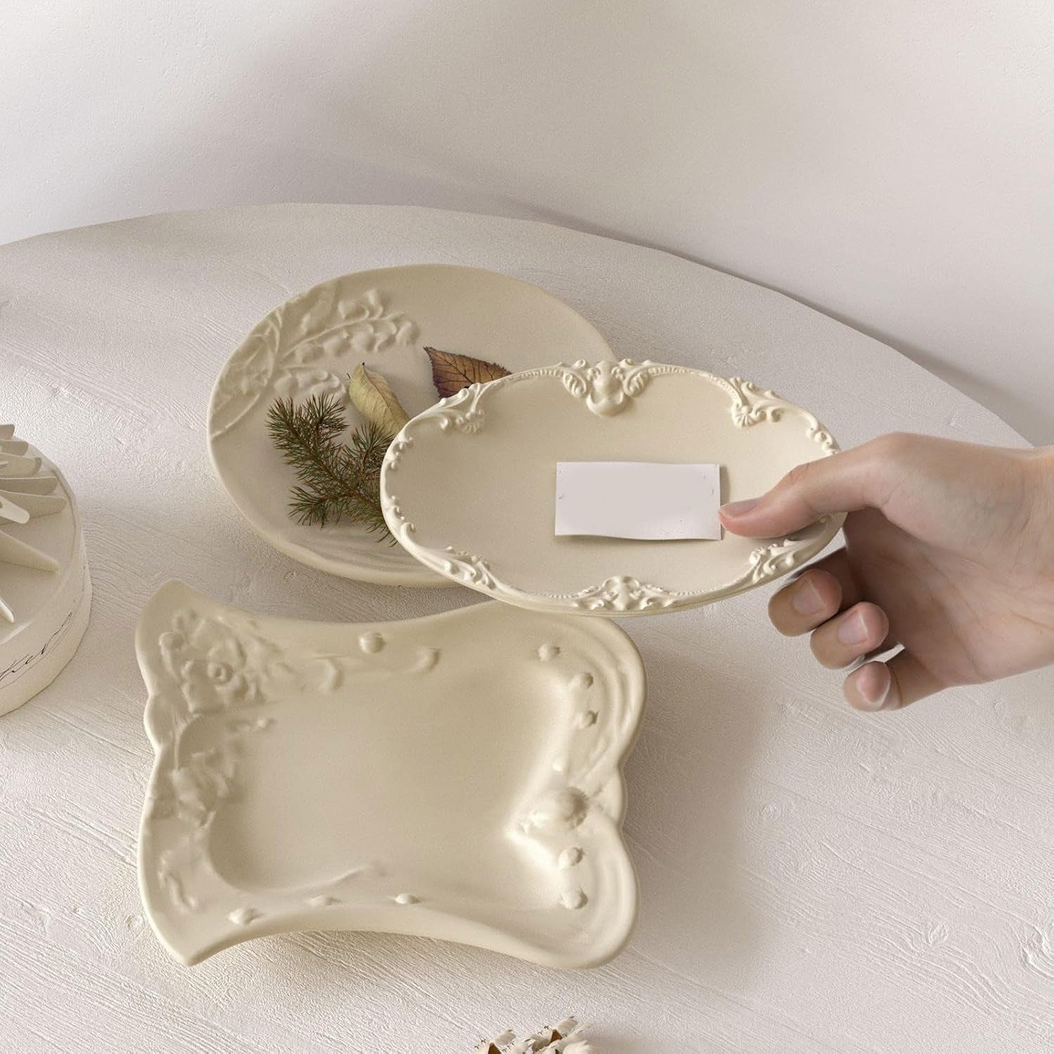 All 3 finished cream vintage floral trays styled together on a white surface with dried flowers