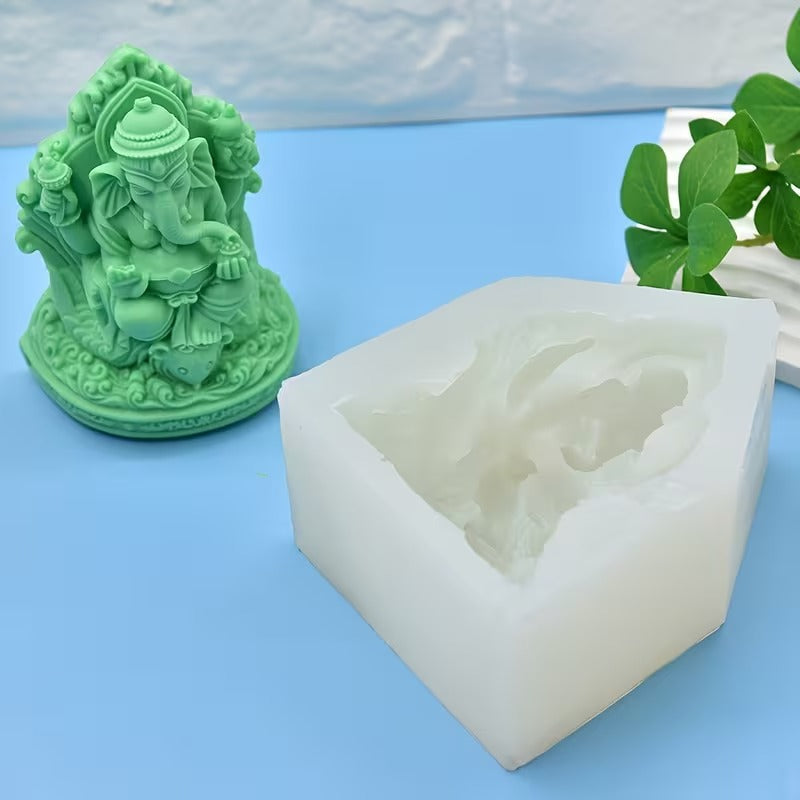 Close-up of detailed green Ganesha resin figurine showing ornate throne and mouse at feet