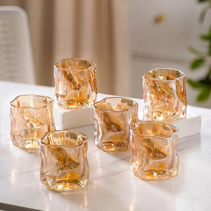Amber crinkle glass candle jar, hero product shot on marble