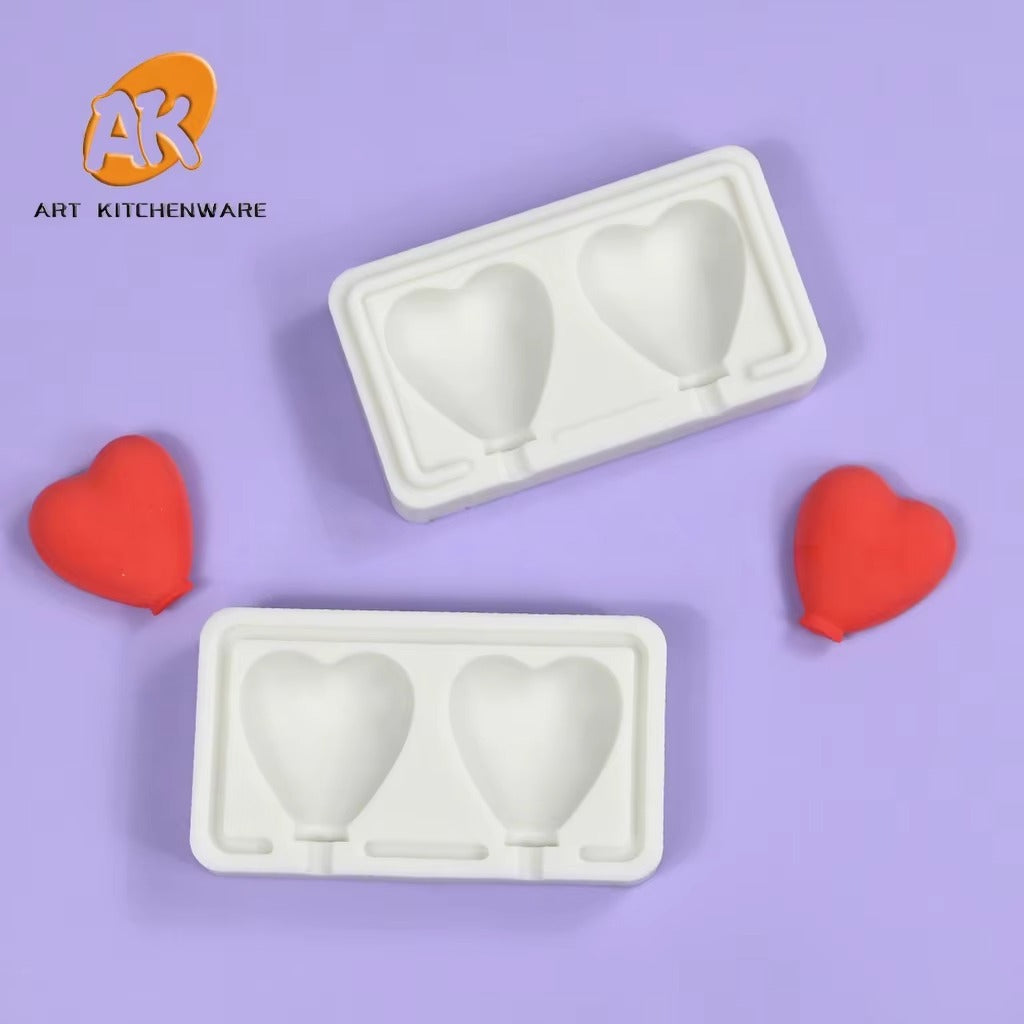 Two views of the white heart lollipop mould with two cavities and stick channels on a purple background