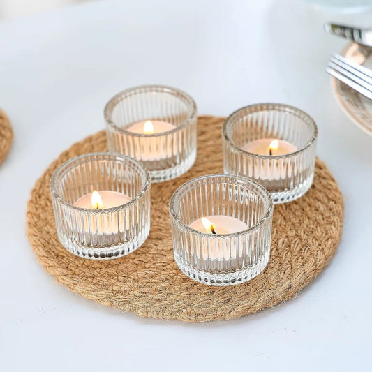 Pack of 6 ribbed glass tealight holders with candles lit
