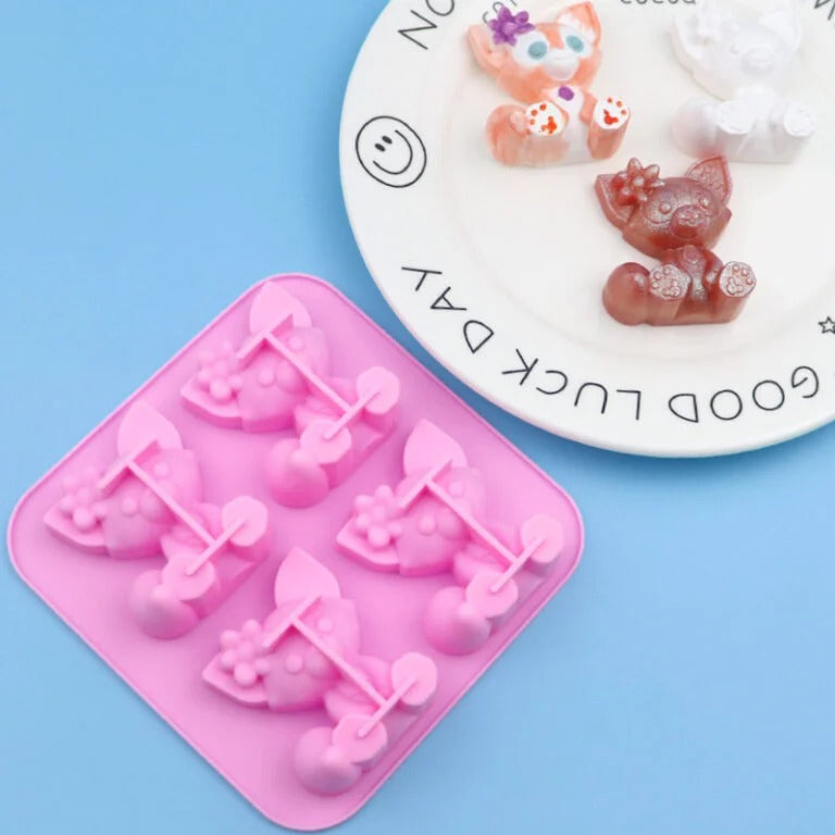 Cat silicone mould with finished colourful resin cat figurines on a plate