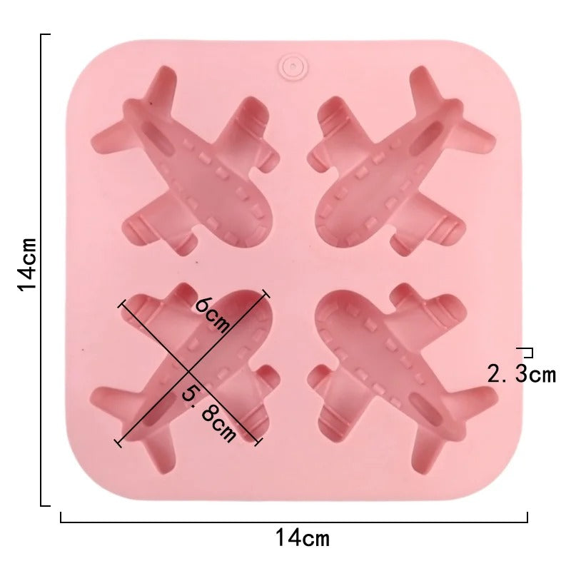 Blue and grey airplane resin figurines next to pink silicone mould