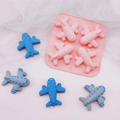 Airplane silicone mould with colourful finished airplane figurines on a plate