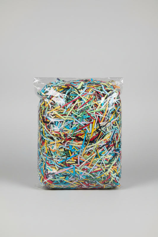 Colourful shredded paper gift box filler in a clear bag