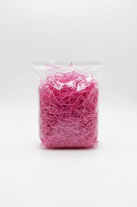 Pink fuchsia shredded paper gift box filler in a clear bag