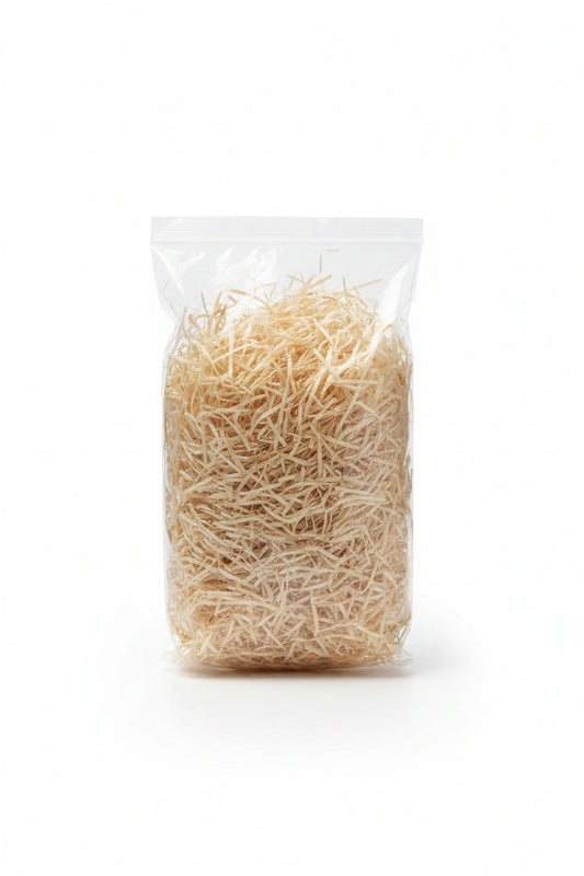 White cream natural shredded wooden gift box filler in a clear bag