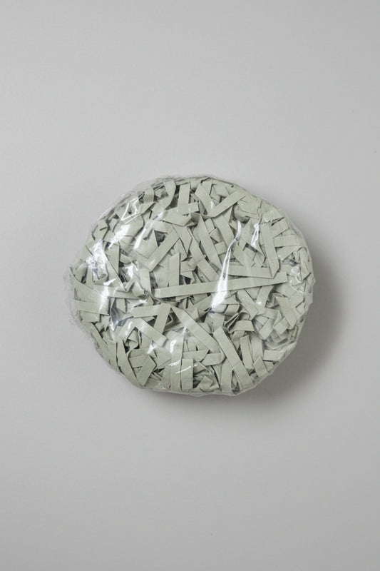 Sage grey shredded paper gift box filler in a clear bag