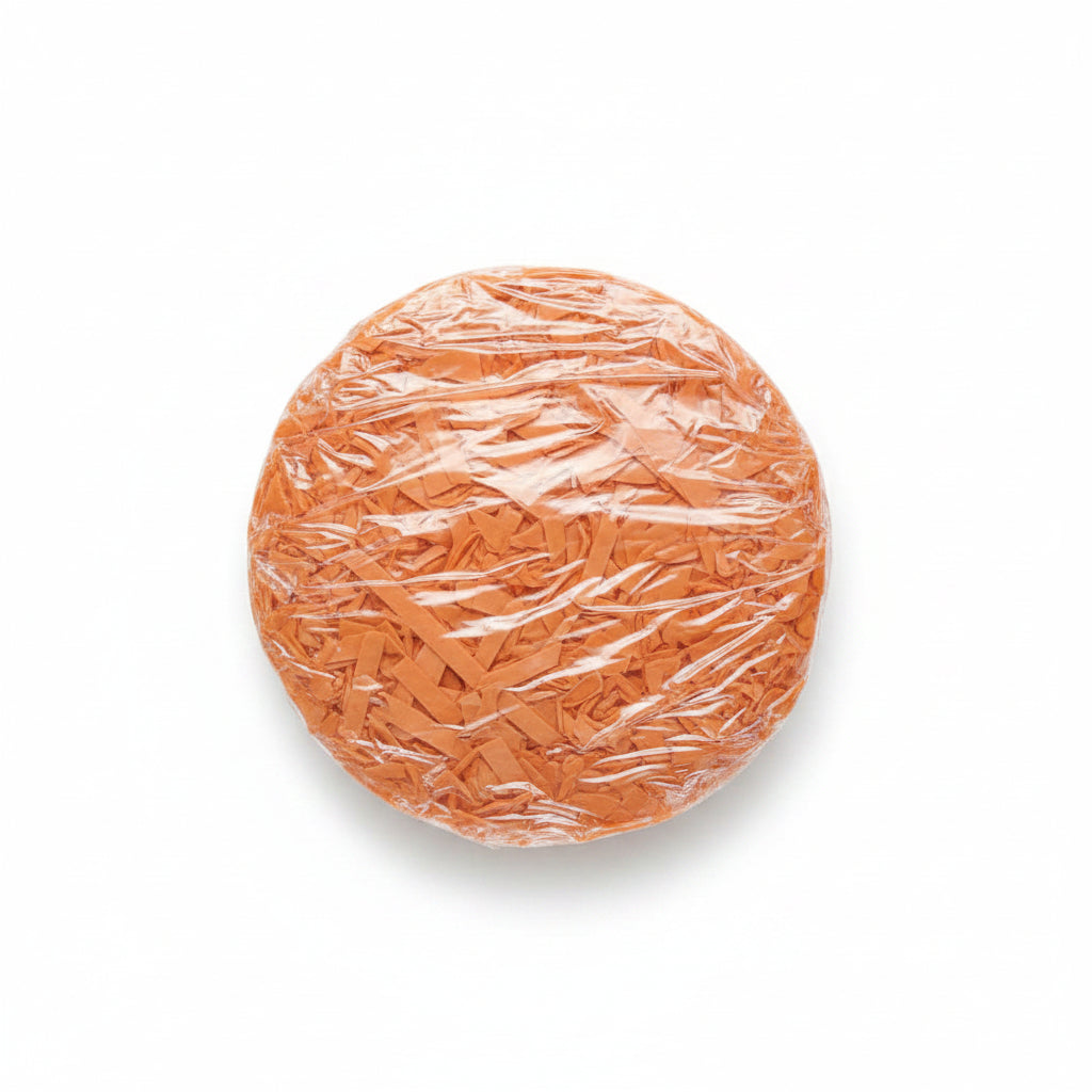Peach salmon shredded paper gift box filler in a clear bag