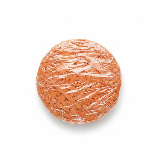 Peach salmon shredded paper gift box filler in a clear bag