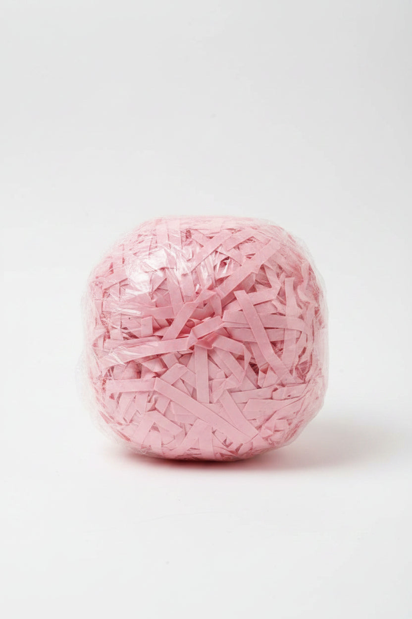 Blush pink rose shredded paper gift box filler in a clear bag