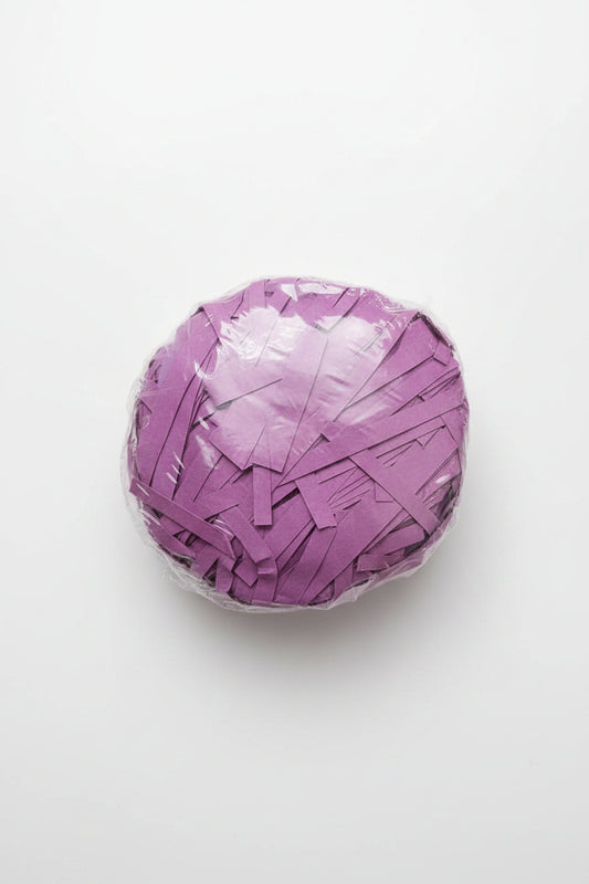 Purple violet shredded paper gift box filler in a clear bag