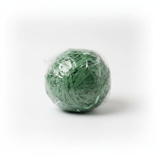 Green shredded paper gift box filler in a clear bag