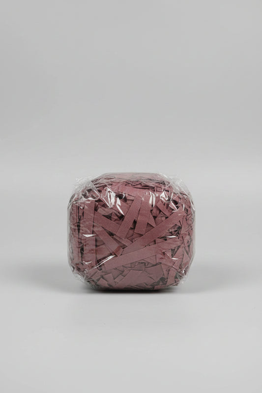 Mauve dusty rose shredded paper gift box filler in a clear bag