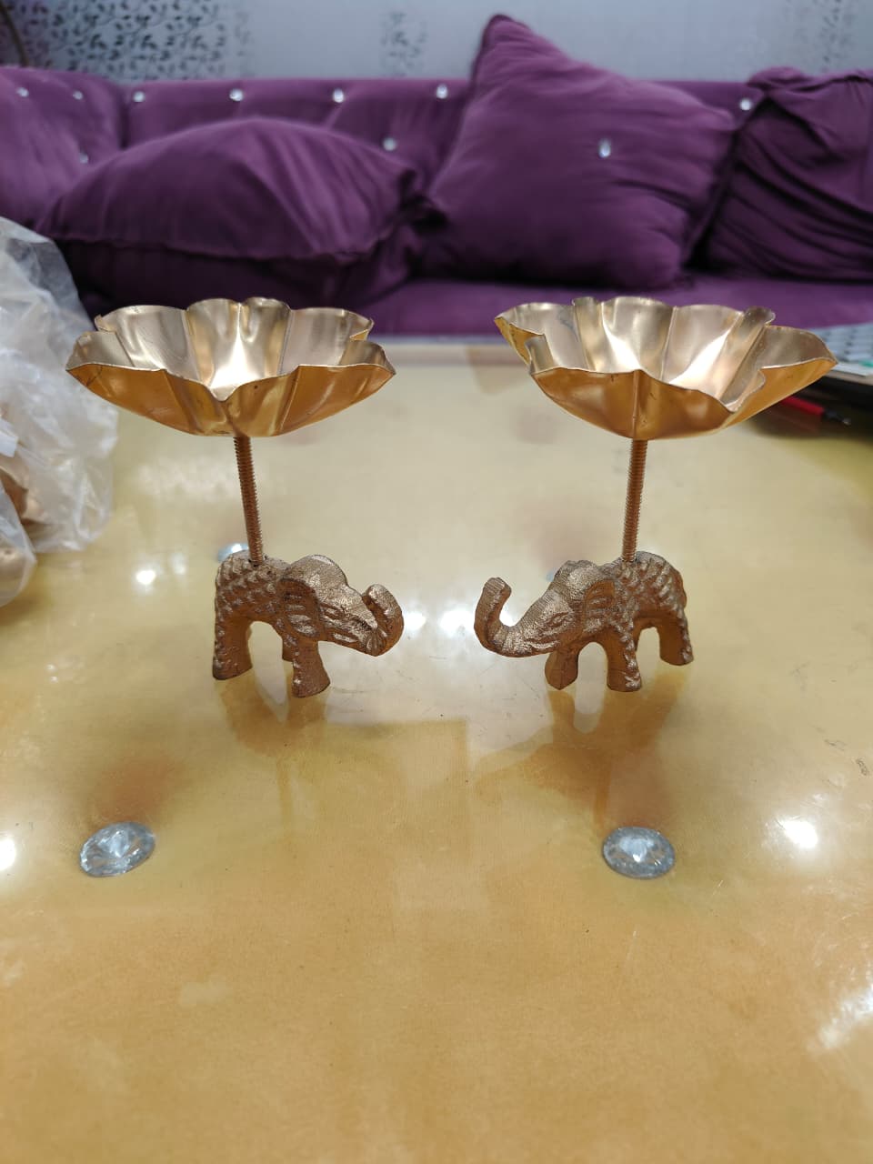 Pair of copper gold tall stem elephant lotus bowl diya holders, front view