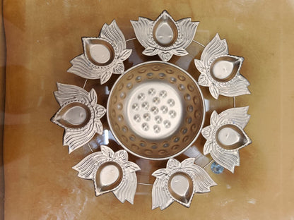 Gold lotus diya urli with 8 lotus flower-shaped diya holders surrounding central bowl, top view