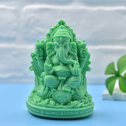 White 3D Lord Ganesha silicone mould with finished green Ganesha figurine on blue background