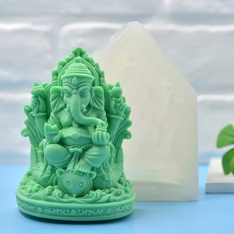 White Ganesha silicone mould beside finished green Ganesha figurine showing front detail