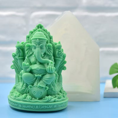 White Ganesha silicone mould beside finished green Ganesha figurine showing front detail