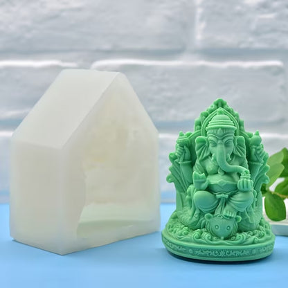White Ganesha silicone mould beside finished green Ganesha figurine showing side profile
