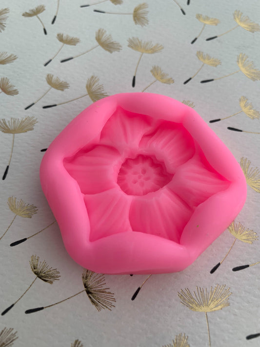 Ivory wax narcissus flower casting made from the mould, displayed on iridescent surface