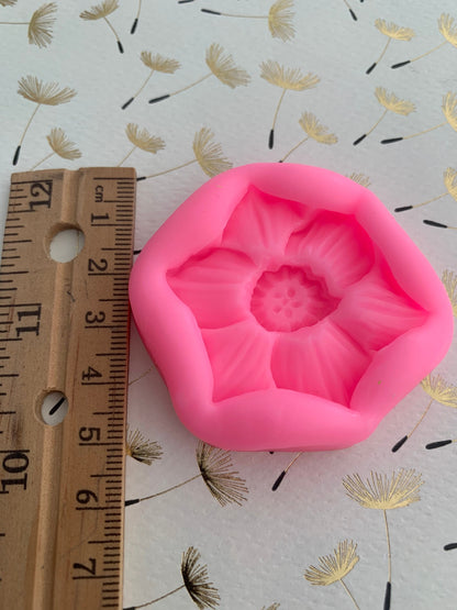 Narcissus flower silicone mould in pink with ruler showing approx 5cm height, side view