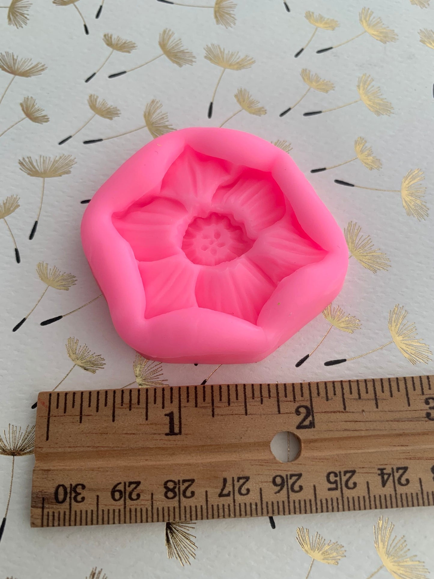 Narcissus flower silicone mould in pink, standalone product shot on dandelion print background