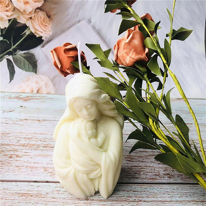 Ivory mother-and-baby sample candle displayed beside roses