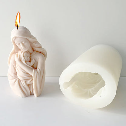 Mother-and-baby candle mould beside a lit Madonna and Child sample candle; finished candle not included