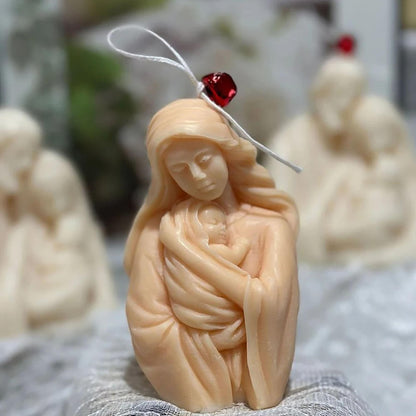 Mother-and-baby sample casting decorated with a hanging cord and red bell; accessories not included