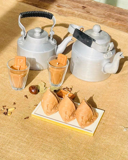 Golden samosa candle with realistic crimped pastry folds and triangular shape