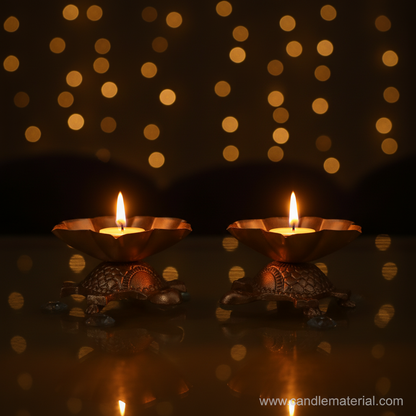 Tortoise lotus diya holders with lit candles, dark moody background with bokeh
