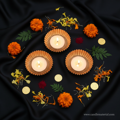 Flat lay of copper gold diya bowls with puja styling and gold coins