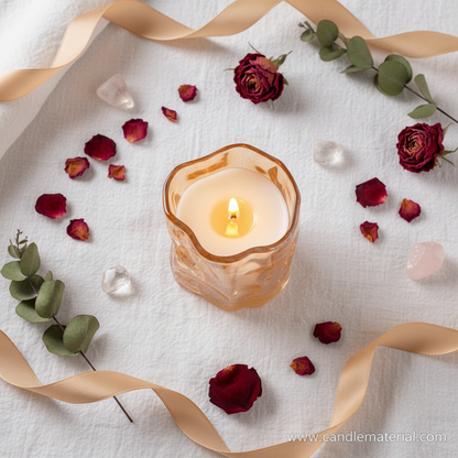 Flat lay of amber crinkle glass candle jar with dried botanicals and crystals