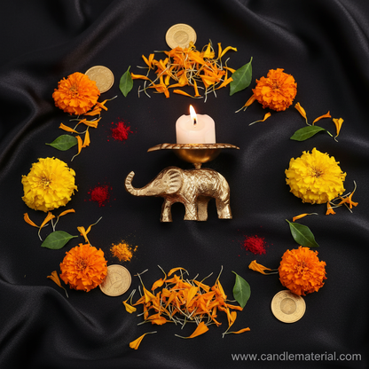 Flat lay of brass elephant diya with puja styling and gold coins