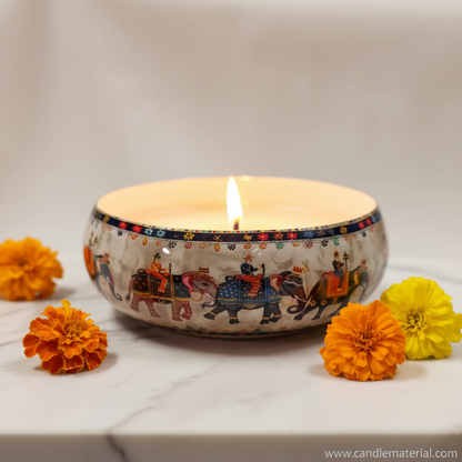 Elephant bowl with lit candle on marble surface with marigolds