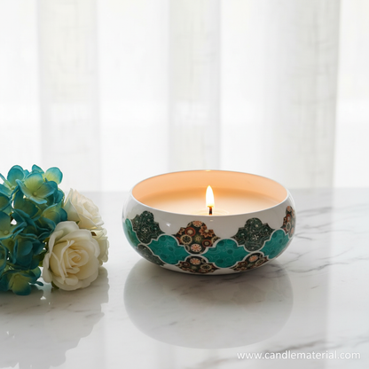 Teal tile candle bowl with lit candle on marble surface with teal flowers